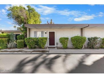 Charming single-story home featuring a tidy front yard, desert landscaping and a freshly painted exterior at 4800 N 68Th St # 207, Scottsdale, AZ 85251