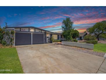 Charming single-story home featuring a two-car garage and a well-manicured lawn under a gorgeous sky at 500 E Hermosa Dr, Tempe, AZ 85282
