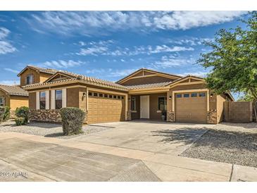 Charming single-Gathering home featuring a three-car garage, neutral paint, and well-maintained landscaping at 6815 W Carter Rd, Laveen, AZ 85339