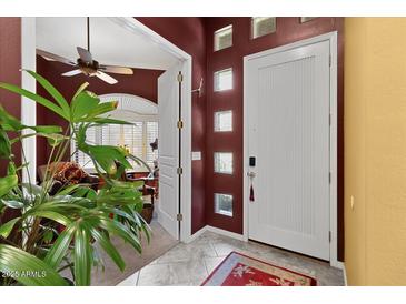 Inviting front entrance with tiled floors and a decorative front door with sidelight windows at 742 W Puget Ave, Phoenix, AZ 85021