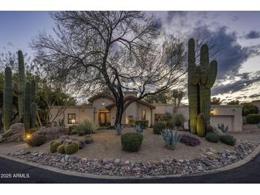 Charming desert home featuring well-manicured landscaping and traditional architecture, creating curb appeal at 8255 E Vista De Valle --, Scottsdale, AZ 85255