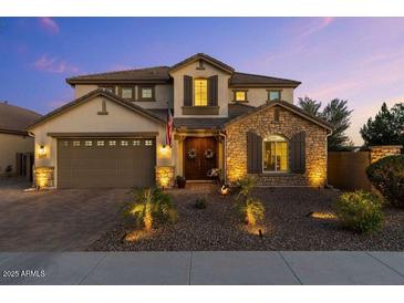 Charming two-story home with a stone accent wall, a manicured front yard, and a two-car garage at 831 E Tonto Pl, Chandler, AZ 85249