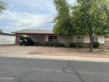 Charming single-story home with a covered carport and low-maintenance rock landscaping at 892 W Dublin St, Chandler, AZ 85225