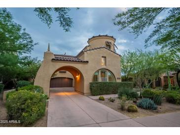 Beautiful Mediterranean home featuring an attached garage, desert landscaping, and distinctive architecture at 18283 N 93Rd St, Scottsdale, AZ 85255