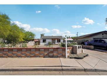 Charming single-story home featuring a well-maintained front yard and a 'For Sale' sign at 2118 E Oak St, Phoenix, AZ 85006