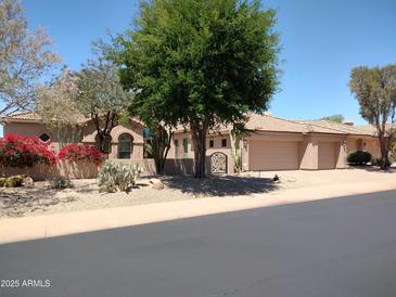 Charming single-story home features beautiful landscaping and a three-car garage at 22436 N 55Th St, Phoenix, AZ 85054