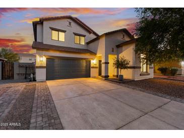 Inviting two-story home featuring desert landscaping, a spacious driveway, and a convenient two-car garage at 2533 W Novak Way, Phoenix, AZ 85041