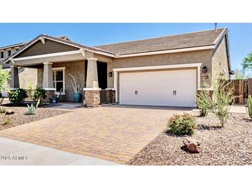 Beautiful single-story home featuring neutral tones, a brick driveway, and a two-car garage at 29403 N 119Th Ln, Peoria, AZ 85383