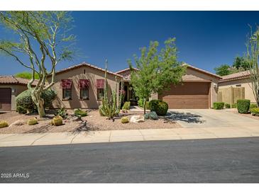 Charming single-story home featuring desert landscaping and a two-car garage at 3336 W Morse Dr, Anthem, AZ 85086