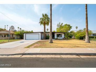 Charming single-story home with a well-maintained front yard and a two-car garage in a sunny neighborhood at 501 E Alameda Dr, Tempe, AZ 85282