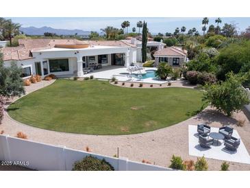 Aerial view of the property showcases lush landscaping, a pool, and multiple outdoor seating areas at 6443 E Malcomb Dr, Paradise Valley, AZ 85253