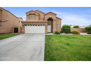 Two-story home featuring a well-kept lawn, large driveway and a two-car garage at 665 S Balboa --, Mesa, AZ 85206