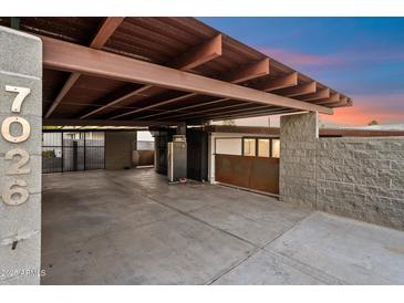 Spacious carport featuring a secure gated entrance, modern concrete, and a sturdy steel structure at 7026 E Pasadena Ave, Paradise Valley, AZ 85253