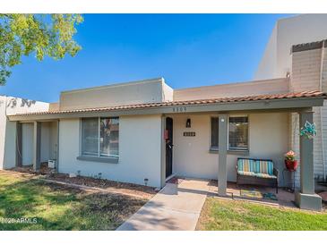 Charming single-story home with covered porch, desert landscaping, and inviting curb appeal at 8309 E Rose Ln, Scottsdale, AZ 85250