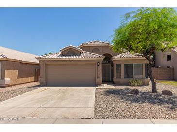 Charming single-story home with a two-car garage and well-maintained landscaping at 8569 W Voltaire Ave, Peoria, AZ 85381