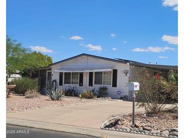 Cozy one-story home with well-maintained landscaping and a private driveway at 8709 E Coralbell Ave, Mesa, AZ 85208