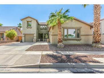 Charming two-story home featuring desert landscaping, and an attached two-car garage at 11580 N 145Th Ave, Surprise, AZ 85379