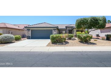 Charming single-story home featuring a well-maintained front yard, desert landscaping, and a two-car garage at 16527 W Blackhawk Ct, Surprise, AZ 85374