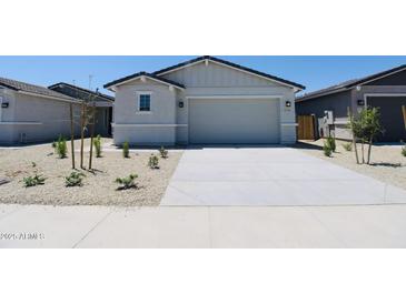Charming single-story home featuring neutral paint, a two-car garage, and low-maintenance landscaping at 17419 W Via De Luna Dr, Surprise, AZ 85387