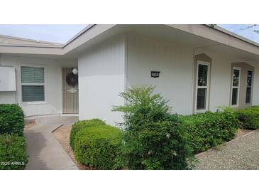 Charming home exterior showcasing well-maintained landscaping and a welcoming entrance and covered walkway at 17463 N Del Webb Blvd, Sun City, AZ 85373