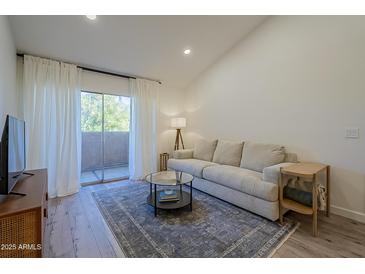 Bright living room with a sliding door, natural light, and neutral tones that offer a serene and inviting atmosphere at 1942 S Emerson -- # 211, Mesa, AZ 85210