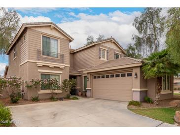 Two-story home features a three car garage, desert landscaping, and a charming balcony at 4254 S Winter Ln, Gilbert, AZ 85297