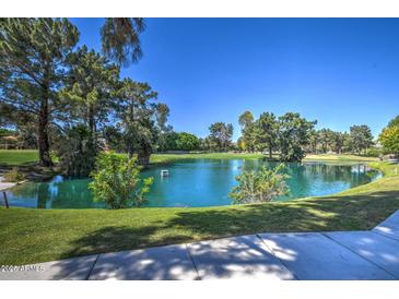 Beautiful serene pond surrounded by mature trees and lush greenery creating a peaceful setting at 5124 N 31St Pl # 514, Phoenix, AZ 85016