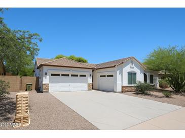 Charming single-story home featuring a three-car garage, desert landscaping, and bright white stucco at 7126 W Ocotillo Rd, Glendale, AZ 85303