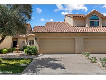 Charming two-story home with a spacious two car garage and a beautiful fountain out front at 7760 E Pepper Tree Ln, Scottsdale, AZ 85250