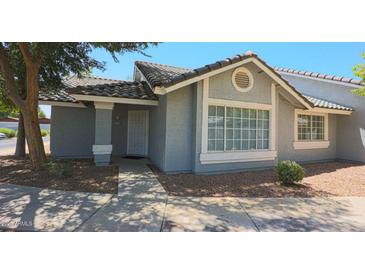 Charming single-story home with desert landscaping, covered entry, and neutral paint at 860 N Mcqueen Rd # 1157, Chandler, AZ 85225