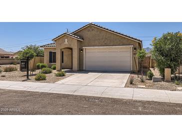 Attractive home with well-kept front yard, showcasing desert landscaping and a spacious two-car garage at 10837 W Bloch Rd, Tolleson, AZ 85353