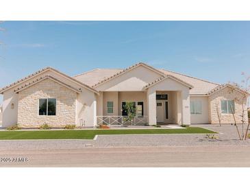 Charming single-story home with stone accents and well-manicured lawn at 1229 N 106Th Pl, Mesa, AZ 85207