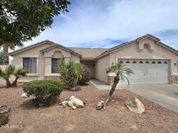 Charming single story home showcasing a low maintenance desert landscape and two-car garage at 1264 W 6Th Ave, Apache Junction, AZ 85120