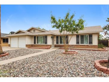 Charming single-story home featuring a low-maintenance rock yard and covered entryway at 3337 W Yucca St, Phoenix, AZ 85029