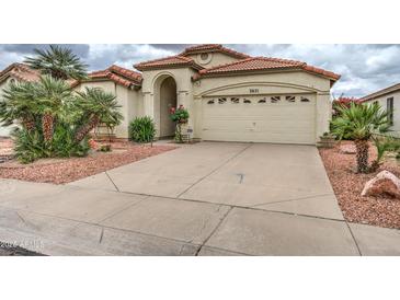 Charming single-story home featuring a well-manicured yard, neutral paint, tile roof, and a two-car garage at 3631 E Long Lake Rd, Phoenix, AZ 85048