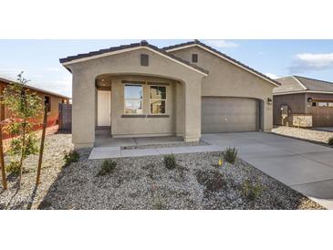 Charming single-story home with a well-maintained front yard and attached two-car garage, providing a welcoming curb appeal at 37535 W Patterson St, Maricopa, AZ 85138