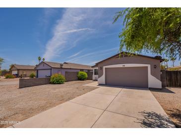 Charming single-story home with a two-car garage, well-maintained landscaping, and a cozy exterior at 719 E Broadway Ave, Apache Junction, AZ 85119