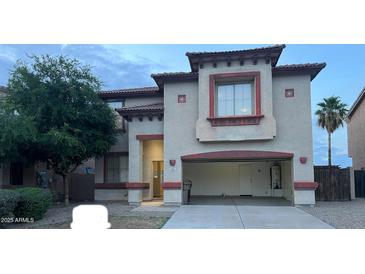 Charming two-story home with an attached garage and desert landscaping in a Gathering-friendly neighborhood at 11016 W Griswold Rd, Peoria, AZ 85345