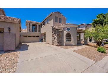 Inviting two-story home featuring a stone facade, balcony, and spacious driveway at 1244 S Tacoma --, Mesa, AZ 85209