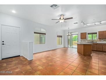 Open-concept living room with tile floors and natural light at 16620 S 48Th St # 79, Phoenix, AZ 85048