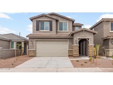 Two-story home features neutral paint, a two-car garage, and low-maintenance landscaping at 17615 W Palo Verde Dr, Litchfield Park, AZ 85340