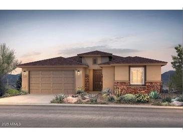 Charming single-story home boasts desert landscaping, a two-car garage, and a welcoming entryway at 17674 W Palo Verde Dr, Litchfield Park, AZ 85340