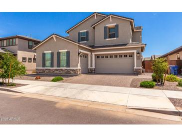 Charming two-story home with neutral stucco, stone accents, and a three-car garage at 20451 E Via De Colina --, Queen Creek, AZ 85142