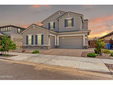 Charming two-story home featuring a three car garage, manicured landscaping, and inviting curb appeal at 20451 E Via De Colina --, Queen Creek, AZ 85142