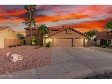 Charming two-story home boasts a spacious three-car garage and well-manicured desert landscaping at 3805 E Desert Flower Ln, Phoenix, AZ 85044