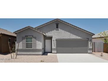 Charming single-story home featuring a two-car garage and low-maintenance desert landscaping at 47702 W Cansados Rd, Maricopa, AZ 85139