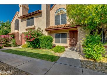 Inviting townhome featuring well-maintained landscaping and a private entrance with a charming walkway at 4901 E Kelton Ln # 1052, Scottsdale, AZ 85254