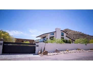 Modern home boasts a unique architectural design with desert landscaping and mountain views at 5801 E Surrey Dr, Cave Creek, AZ 85331
