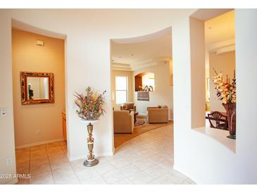 Inviting entryway featuring tile flooring, neutral walls, and arched openings leading to other living spaces at 7413 E Russet Sky Dr, Scottsdale, AZ 85266
