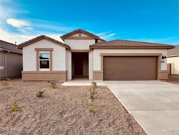 Charming single-story home with a two-car garage and low maintenance landscaping at 11948 E Aster Ln, Florence, AZ 85132